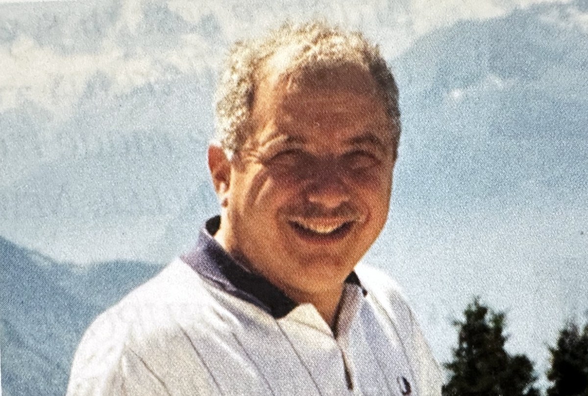 Dr. Martin Vinokur smiling in front of the Alps in Villars, Switzerland, 1996