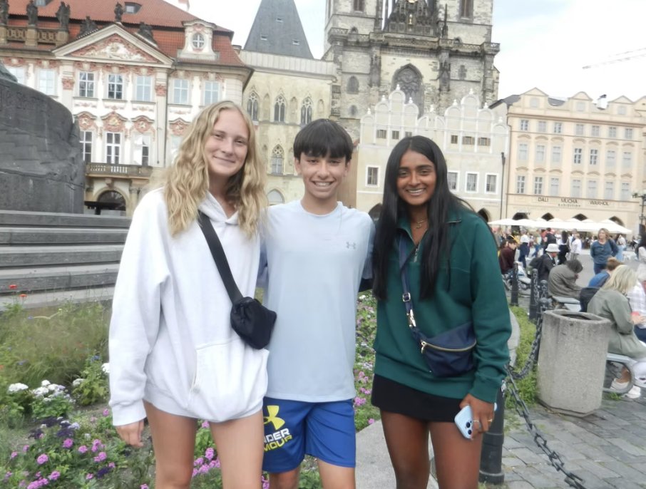 Three teammates in Prague’s Old Town Square
