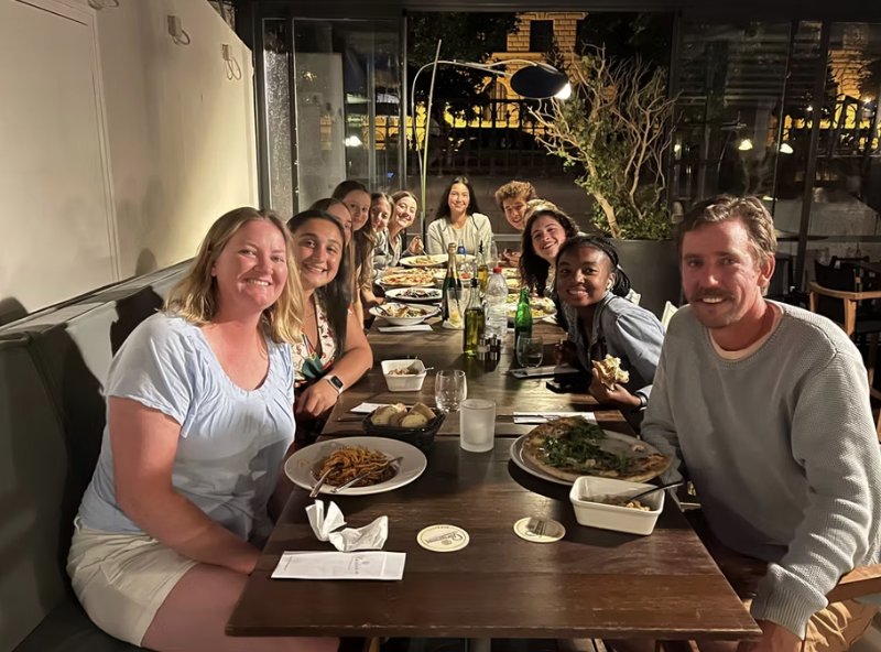 Coaches and the team at dinner after a day of tennis
