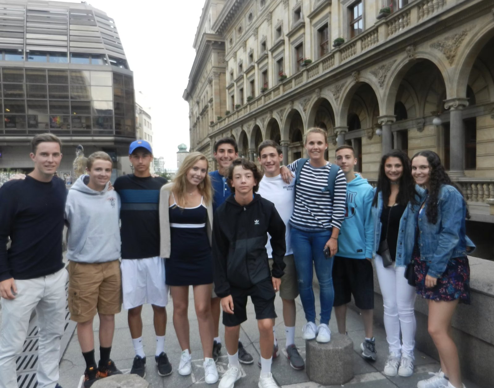 The whole team outside a historic European building